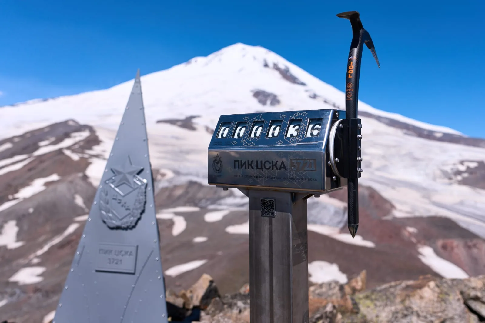 A mountain route marker beneath a glacier