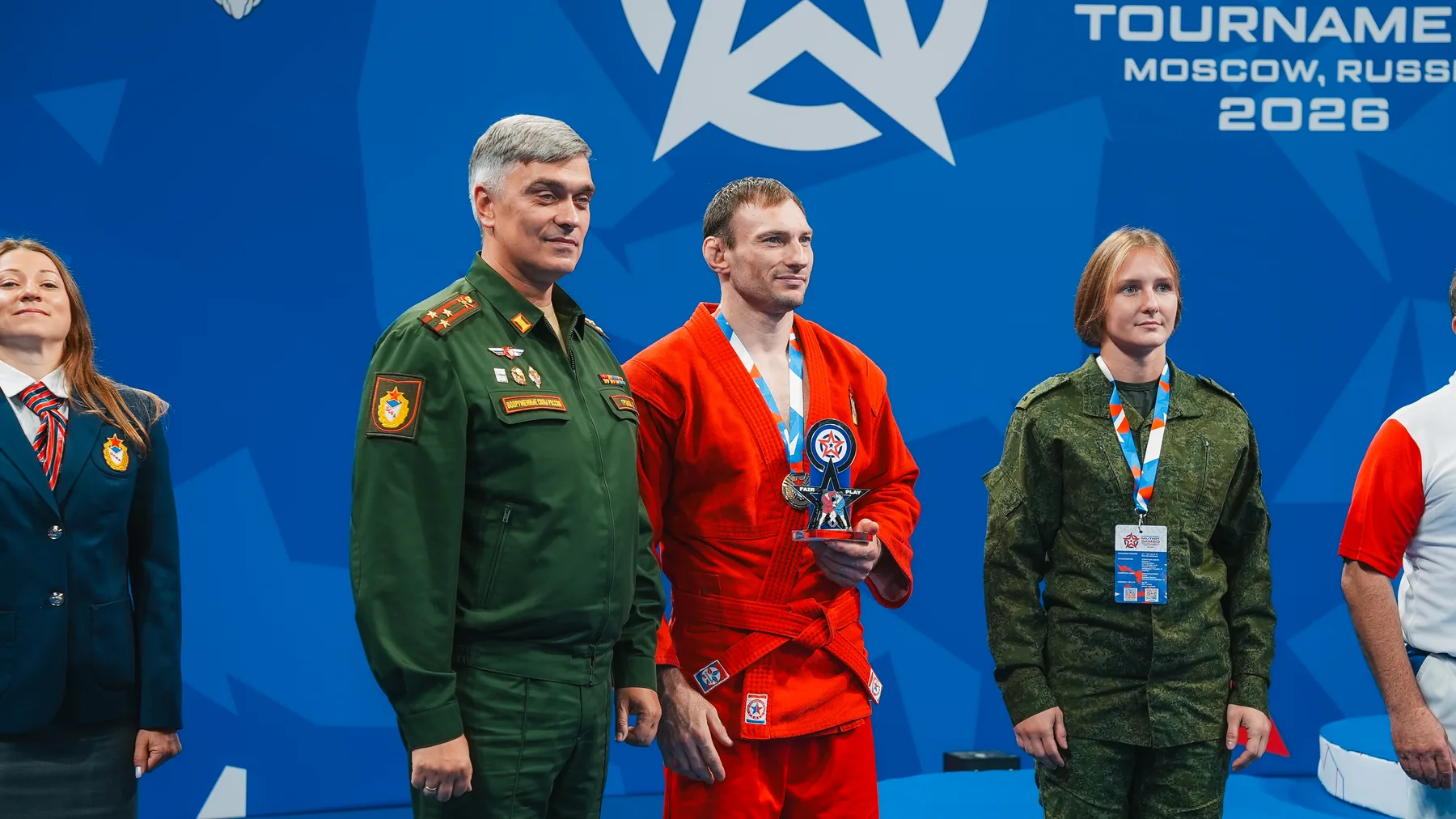 A sambo athlete celebrating with an award